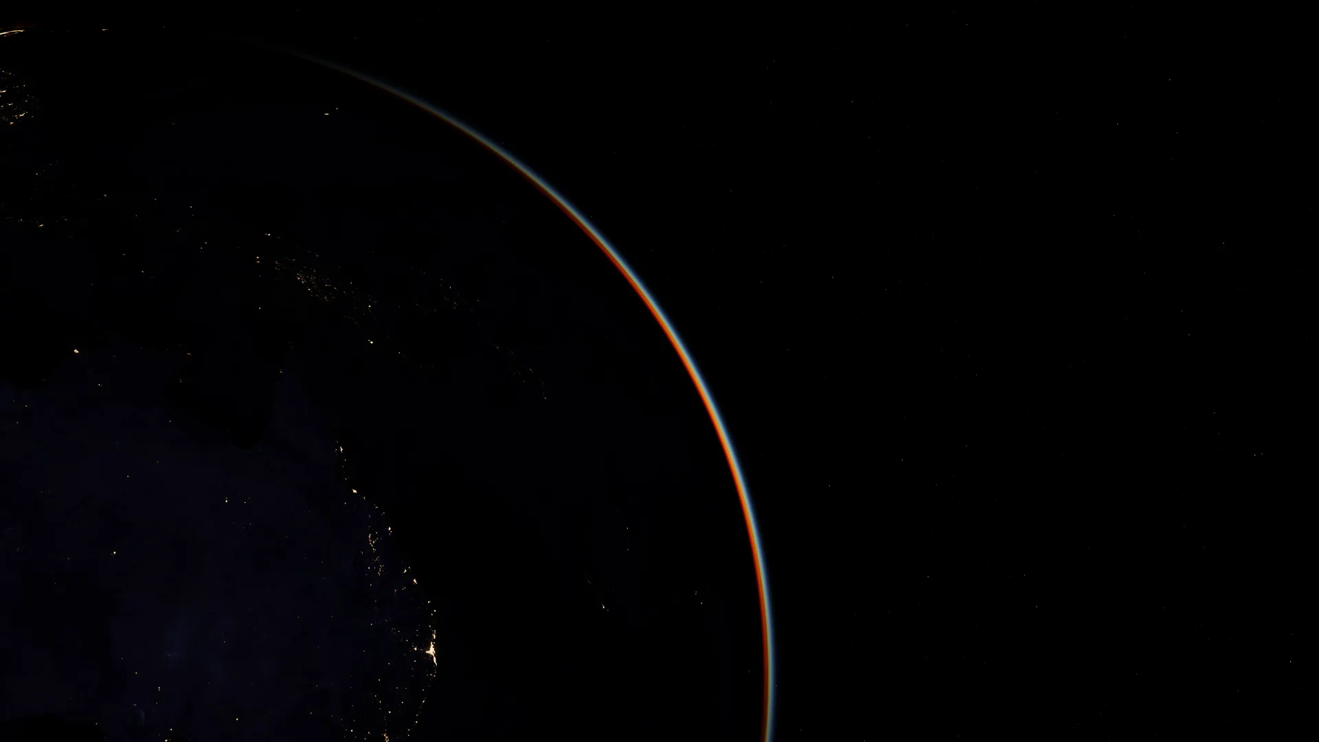 An orbital sunrise with a warm lens flare over the horizon